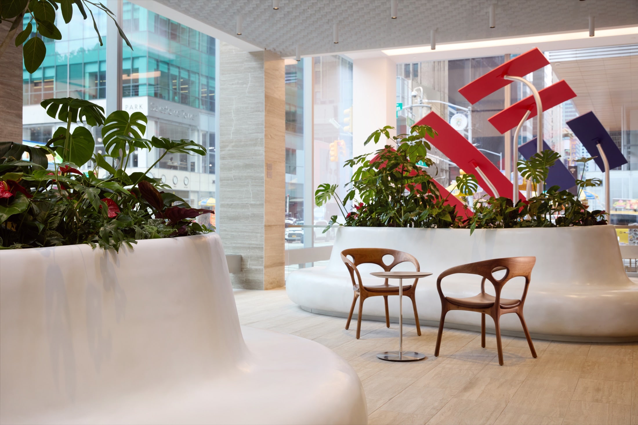 Indoor park environment with concrete benches and planters in a national bank branch, by Greenery NYC