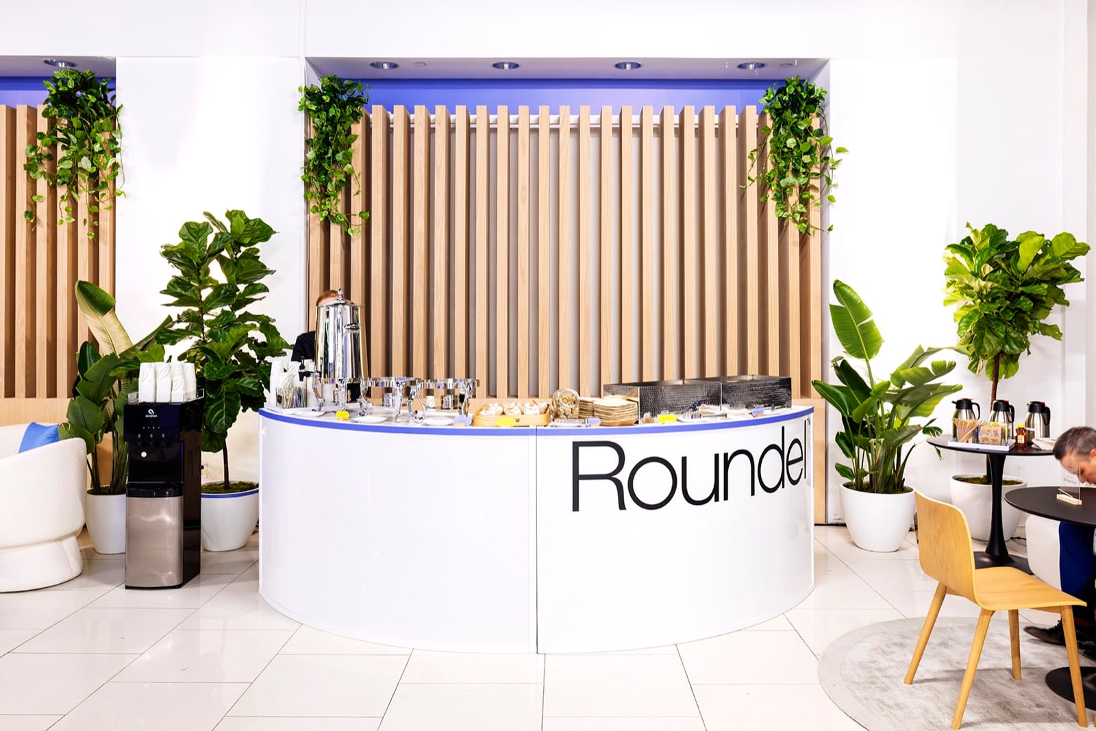 A corporate event catering area styled with live plants by Greenery NYC